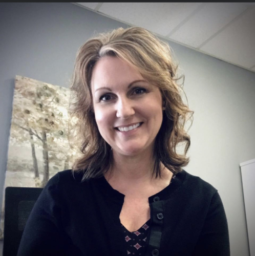 Lori in her office smiling at the camera