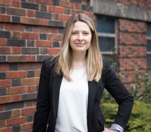 Dr. Alyson Kelvin in corporate wear posing for a picture