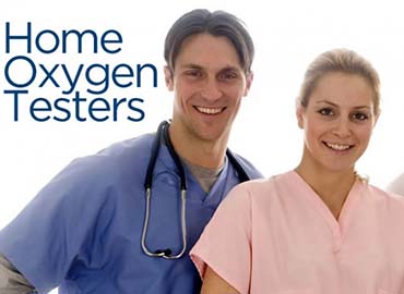 Nurse taking a woman's oxygen level reading, they are both sitting on chairs smiling.