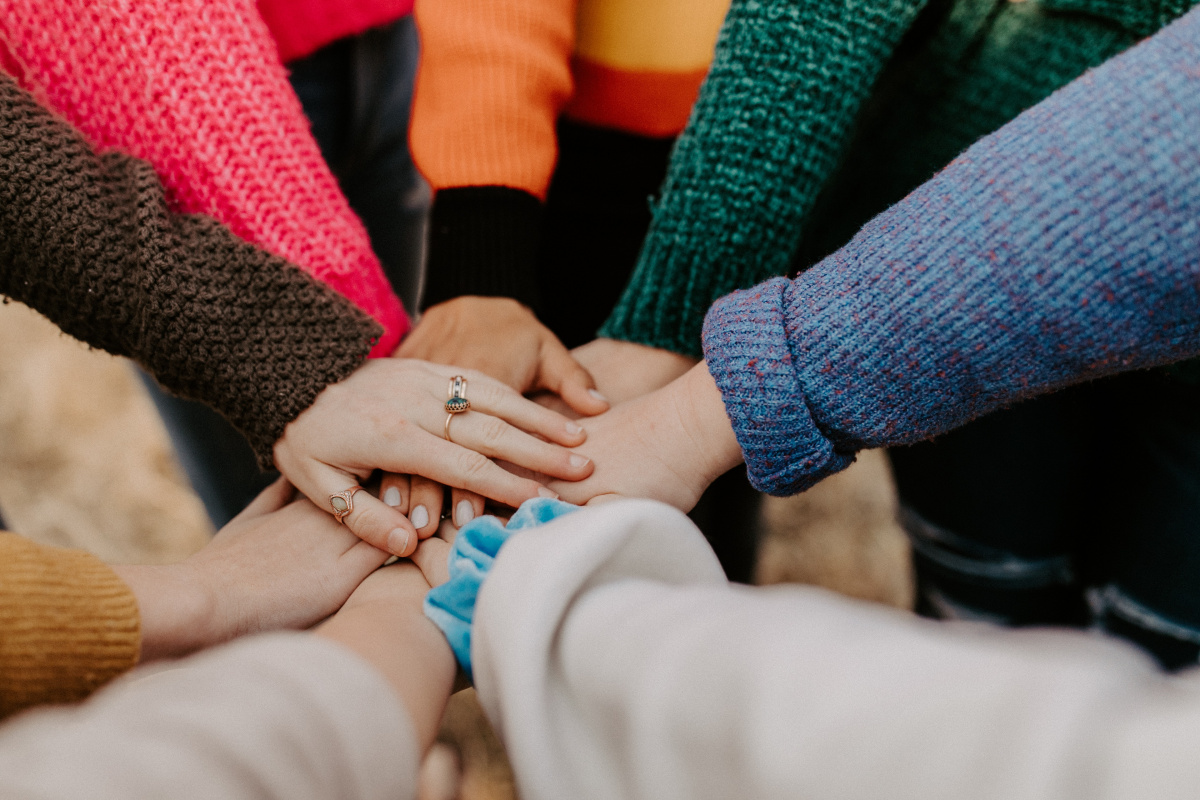 hands all together supporting