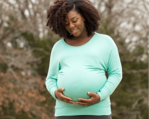 Pregnant woman holding belly