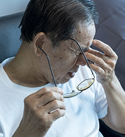 man holding head due to headache