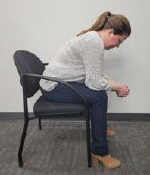 person sitting on a chair leaning forward