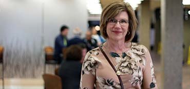 Lead researcher Dr. Goodridge in a hall of people smiling