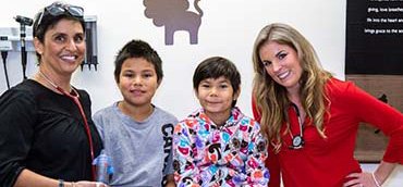 Doctor and nurse with two young children