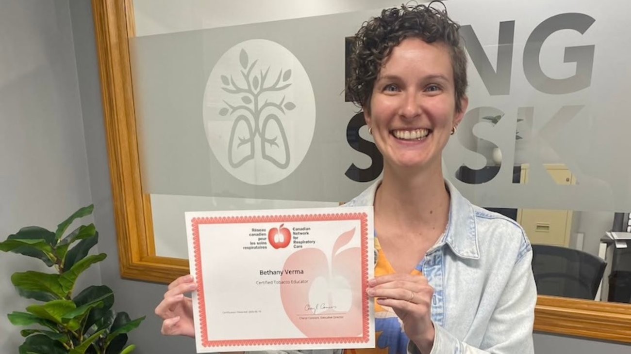 Beth holding her certificate