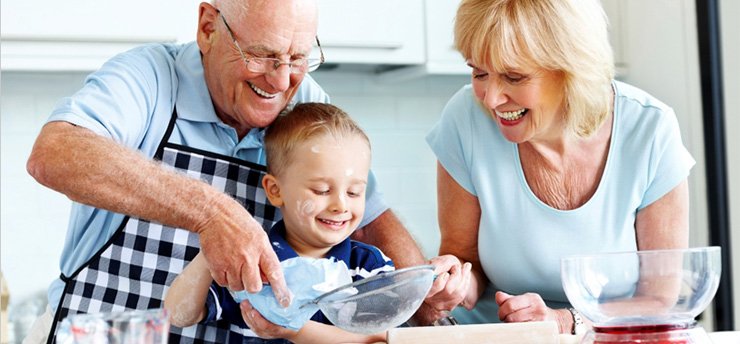 Grandparents in kitchen with grandchild