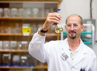 Jeff holding up a beaker in a lab