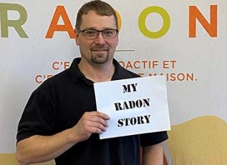 Kevin holding a my radon story sign