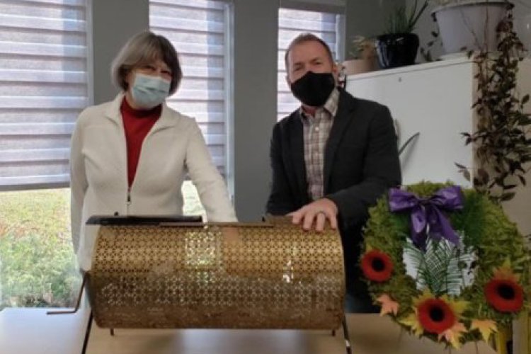 Man and woman standing at raffle bin