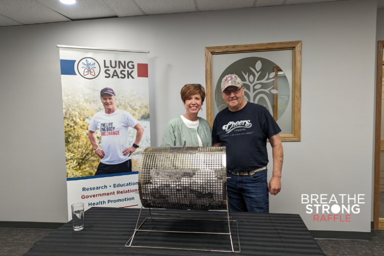 Erin and Ralph standing behind a draw drum