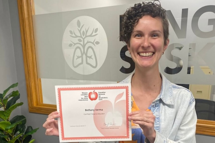 Beth holding her certificate