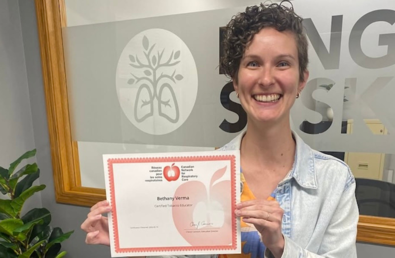 Beth holding her certificate