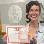 Beth holding her certificate