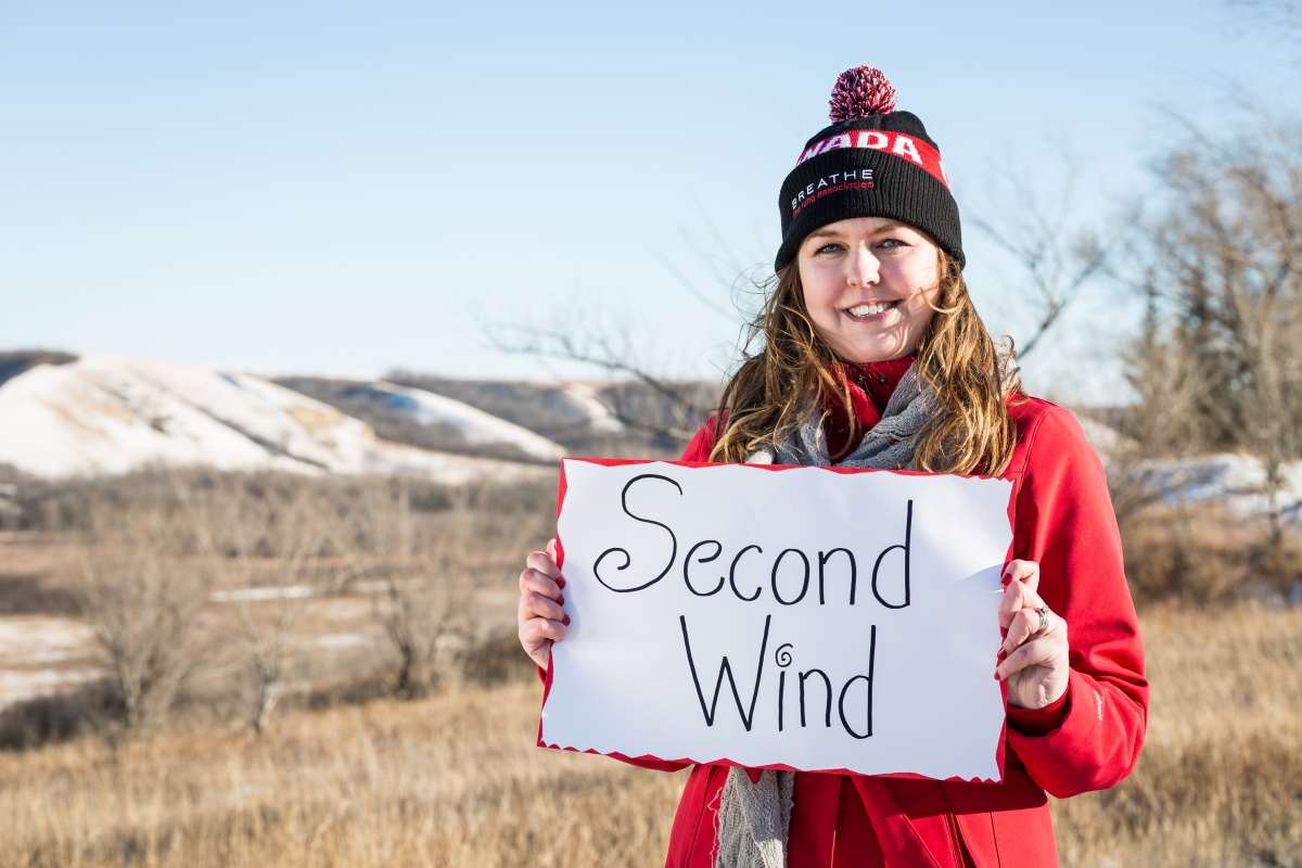 Nicole holding sign that says second wind